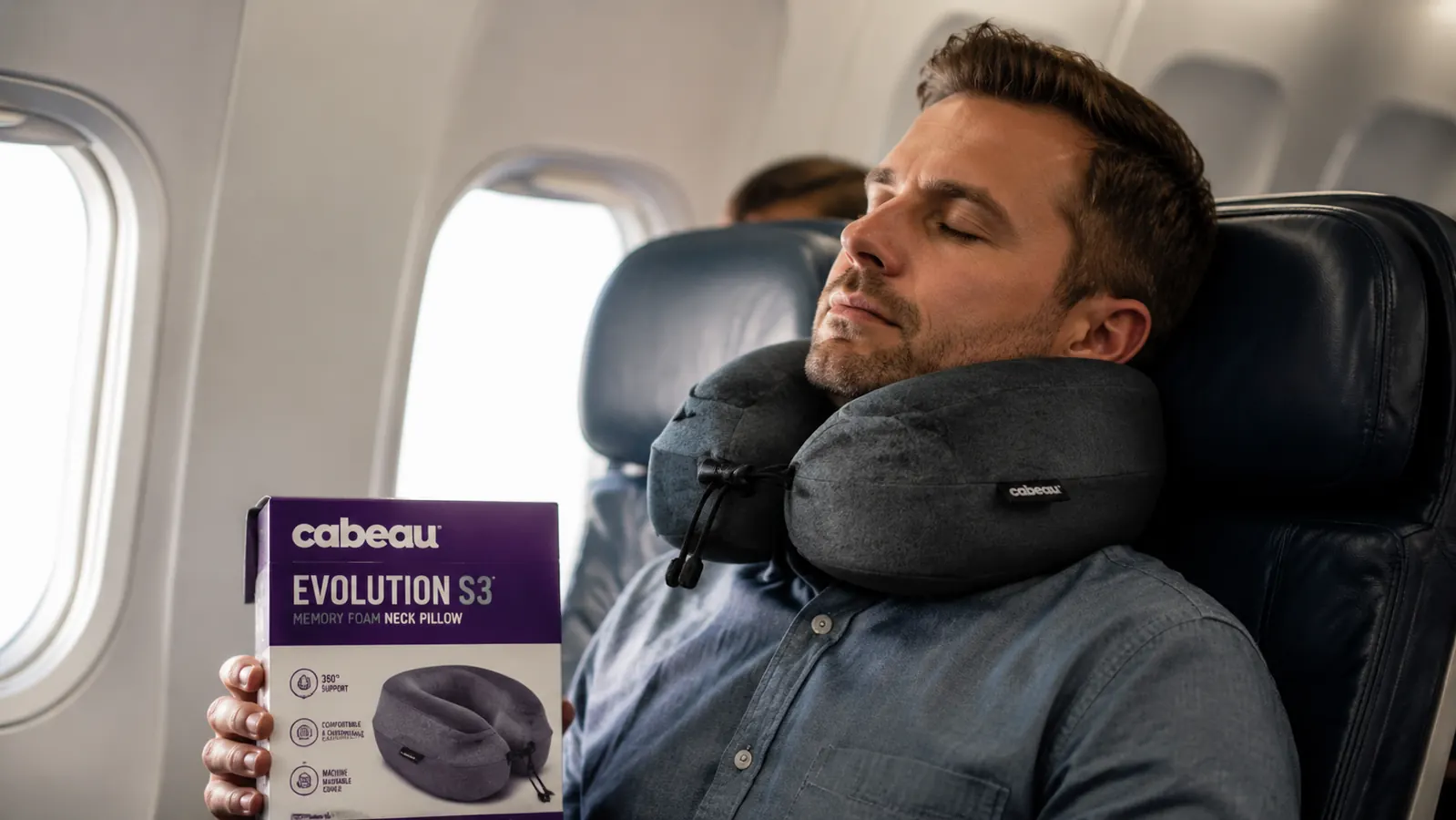 Traveler wearing the Cabeau Evolution S3 neck pillow in an airplane economy seat, eyes closed, head supported upright